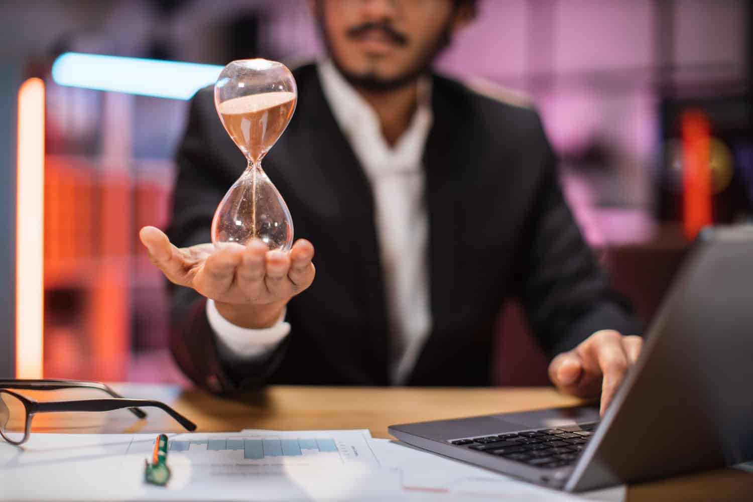 focus hand smiling confident businessman holding hourglass